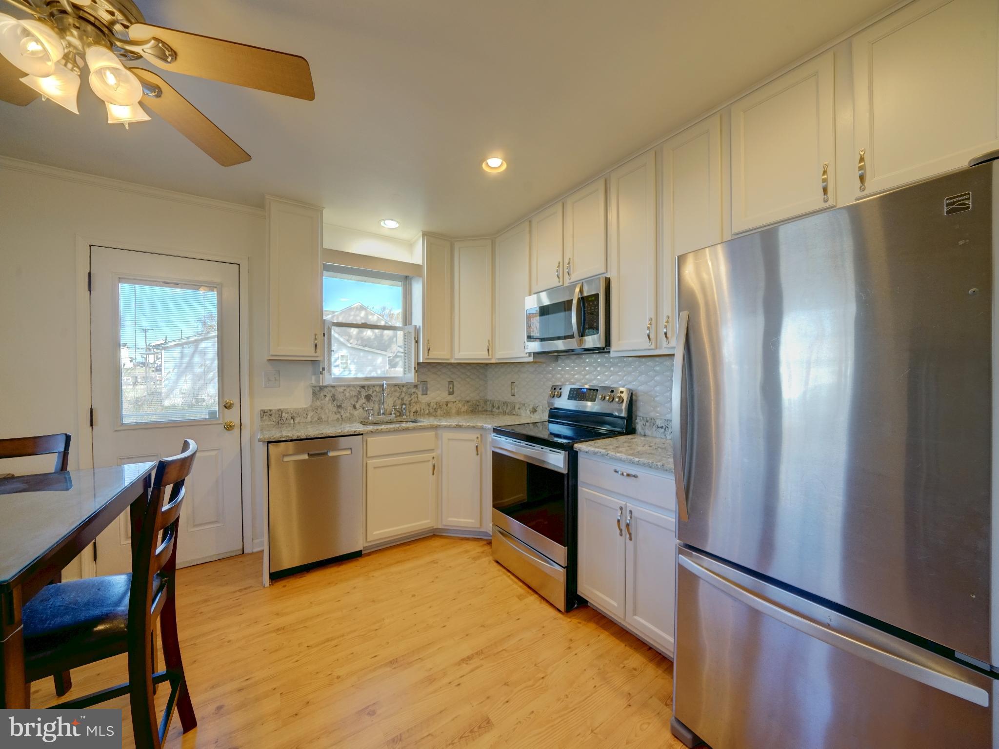 7819 Appletree Road Pasadena, MD 21122 - Photo 7 of 59 Modern kitchen with sleek appliances.