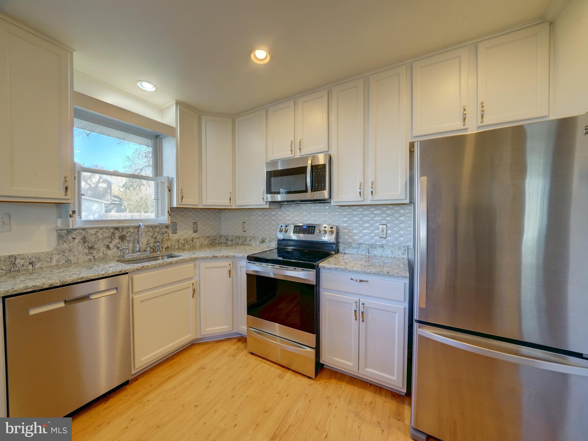 7819 Appletree Road Pasadena, MD 21122 - Photo 8 of 59 Modern kitchen with sleek finishes.