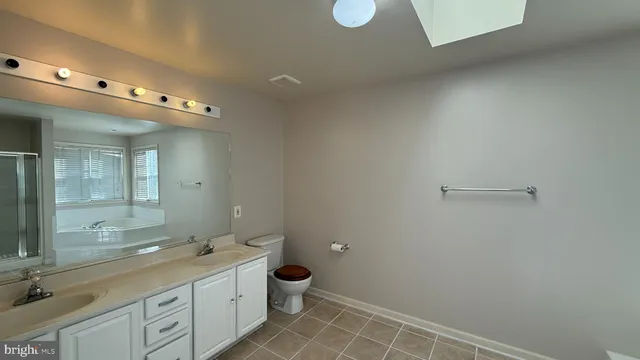 a bathroom with a glass shower door and a window