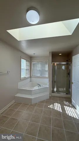 a white toilet sitting next to a bath tub