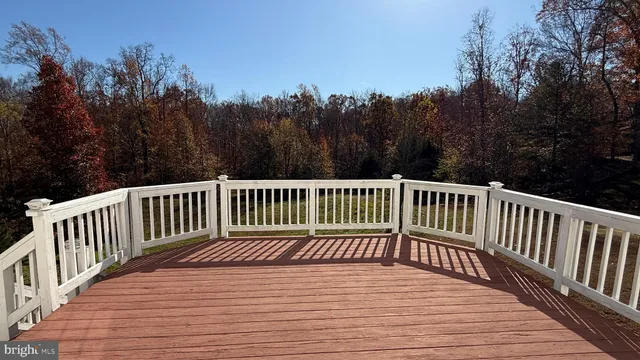 a view of a balcony with wooden chairs