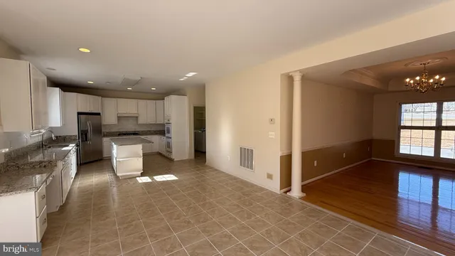 a kitchen with sink and white cabinets