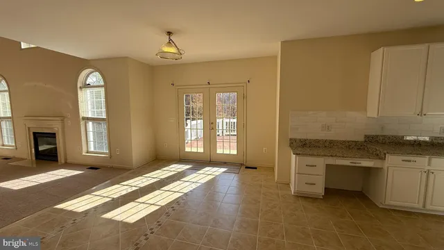 a kitchen with a sink cabinets and wooden floor