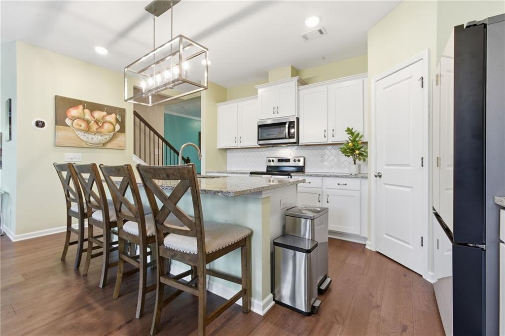 2106 Garden Place Atlanta, GA 30316 - Photo 12 of 37 a kitchen with a table chairs refrigerator and microwave