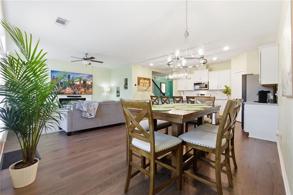2106 Garden Place Atlanta, GA 30316 - Photo 16 of 37 a dining room with furniture a chandelier and wooden floor