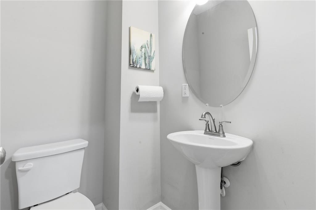 2106 Garden Place Atlanta, GA 30316 - Photo 17 of 37 a bathroom with a sink a toilet and mirror