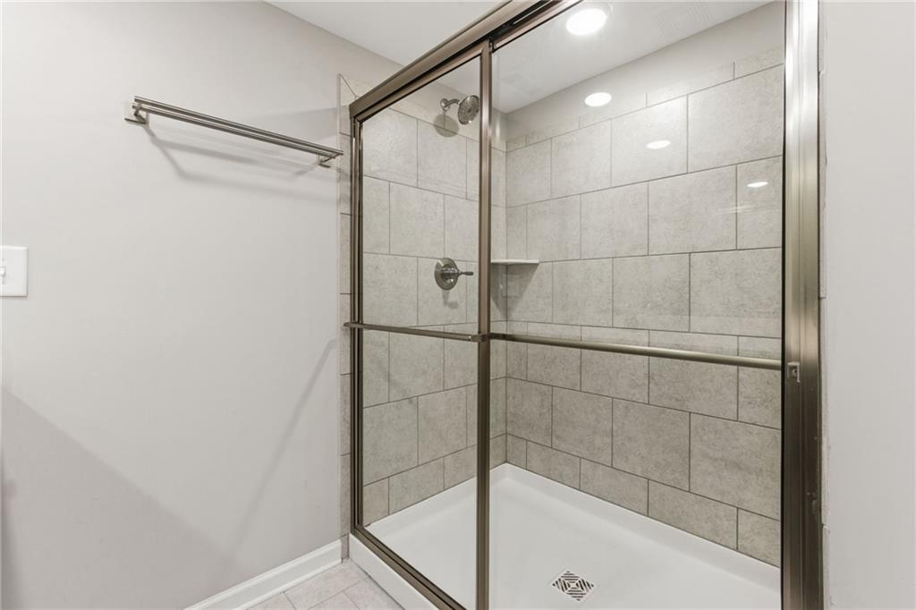 2106 Garden Place Atlanta, GA 30316 - Photo 23 of 37 a bathroom with a glass shower door