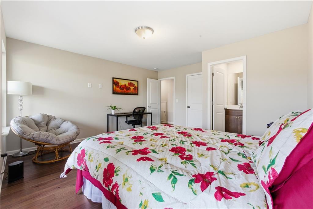 2106 Garden Place Atlanta, GA 30316 - Photo 32 of 37 a bedroom with a bed and a chandelier