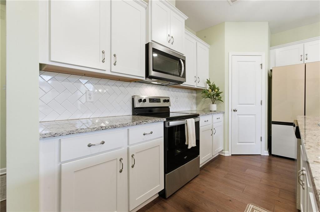 2106 Garden Place Atlanta, GA 30316 - Photo 10 of 37 a kitchen with granite countertop white cabinets and stainless steel appliances