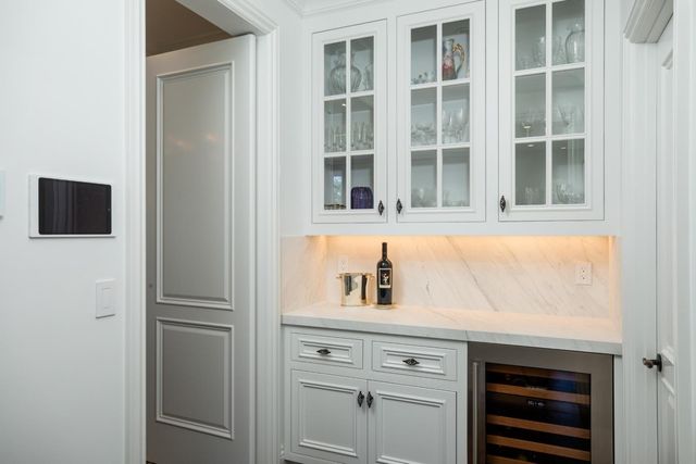 a kitchen with a sink and a mirror
