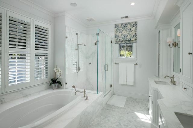 a bathroom with a double vanity sink mirror and shower