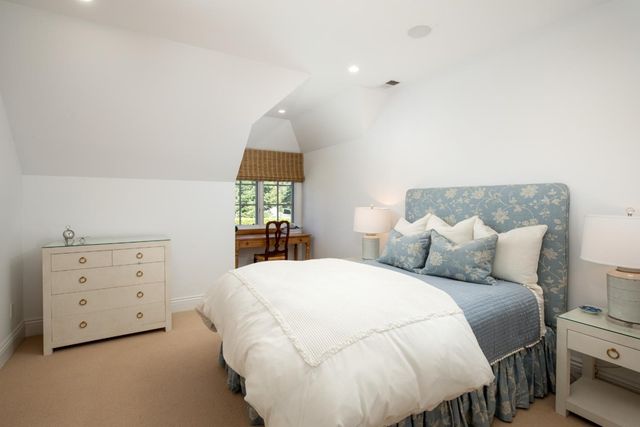 a bathroom with a granite countertop sink a mirror and shower