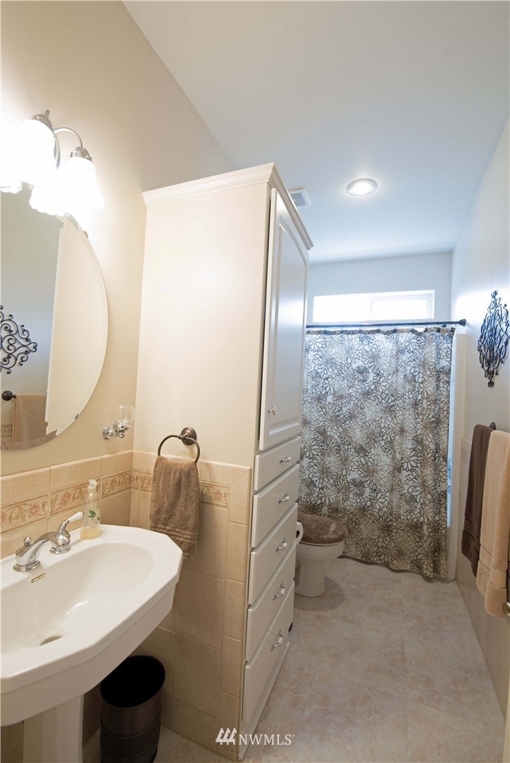 19333 Tall Firs Lane Southwest Rochester, WA 98579 - Photo 3 of 25 a bathroom with a sink and mirror