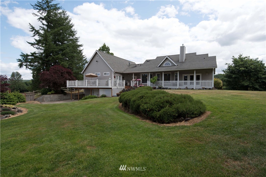 19333 Tall Firs Lane Southwest Rochester, WA 98579 - Photo 22 of 25 a front view of a house with a garden and yard