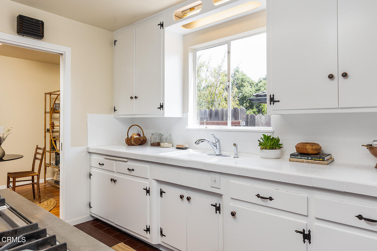4176 Canyon Crest Road Altadena, CA 91001 - Photo 14 of 33 a kitchen with white cabinets and window