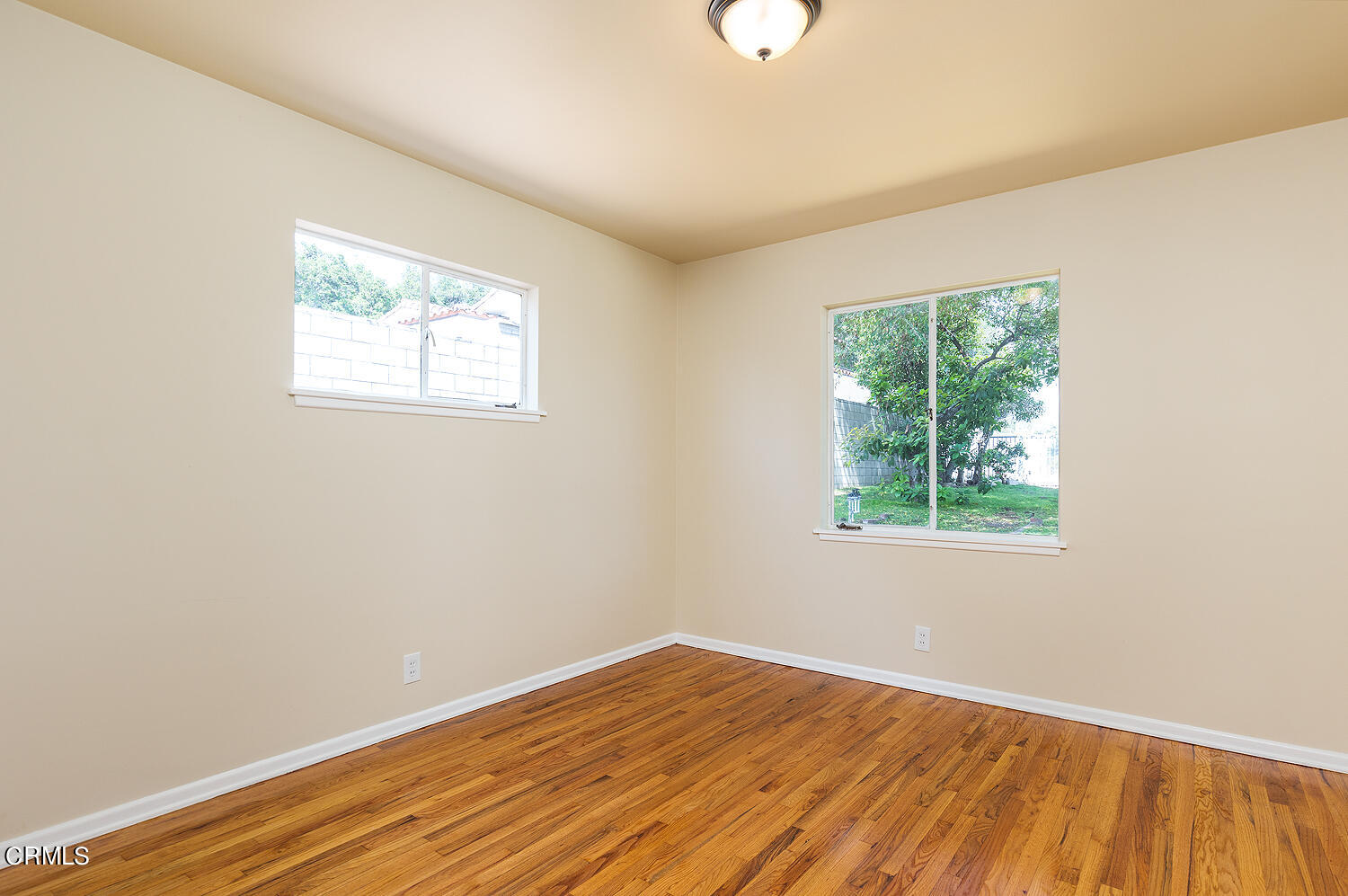 4176 Canyon Crest Road Altadena, CA 91001 - Photo 23 of 33 an empty room with wooden floor and windows