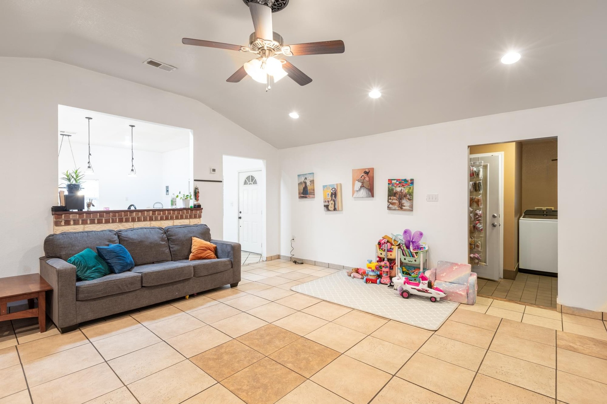 176 Old Lexington Road, Unit C Elgin, TX 78621 - Photo 7 of 31 a living room with furniture and a chandelier