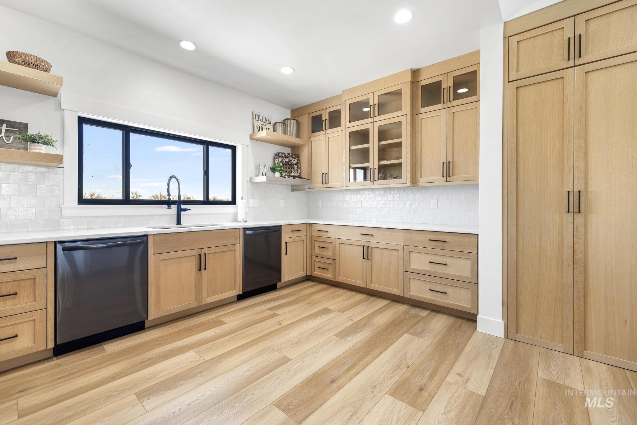 4288 North 2400 East Filer, ID 83328 - Photo 14 of 50 Kitchen with open shelves, glass fronted cabinets, dishwasher, decorative backsplash, and light wood-type flooring