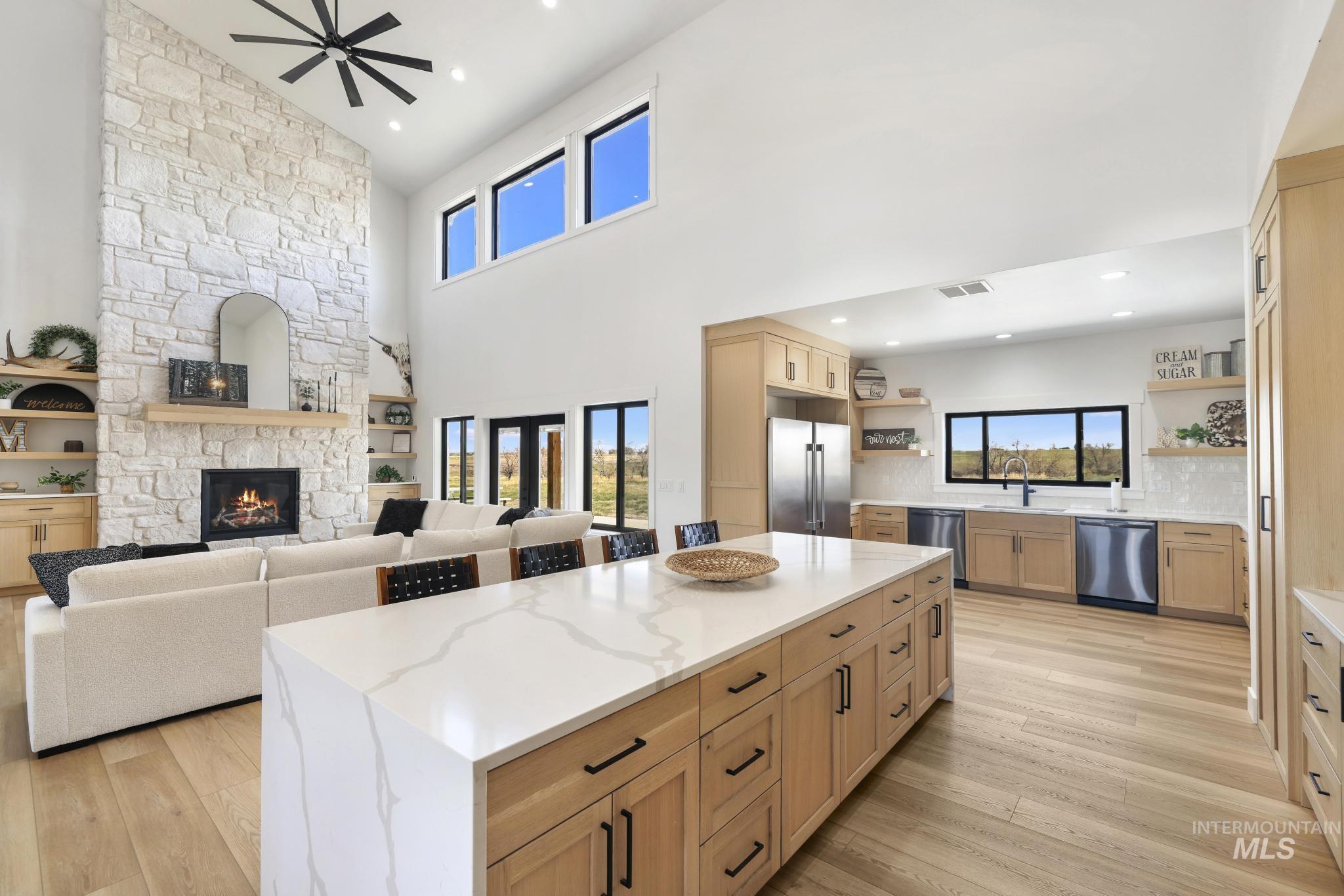 4288 North 2400 East Filer, ID 83328 - Photo 50 of 50 Kitchen with open floor plan, light wood finish cabinetry, light stone counters, stainless steel appliances, and a high ceiling
