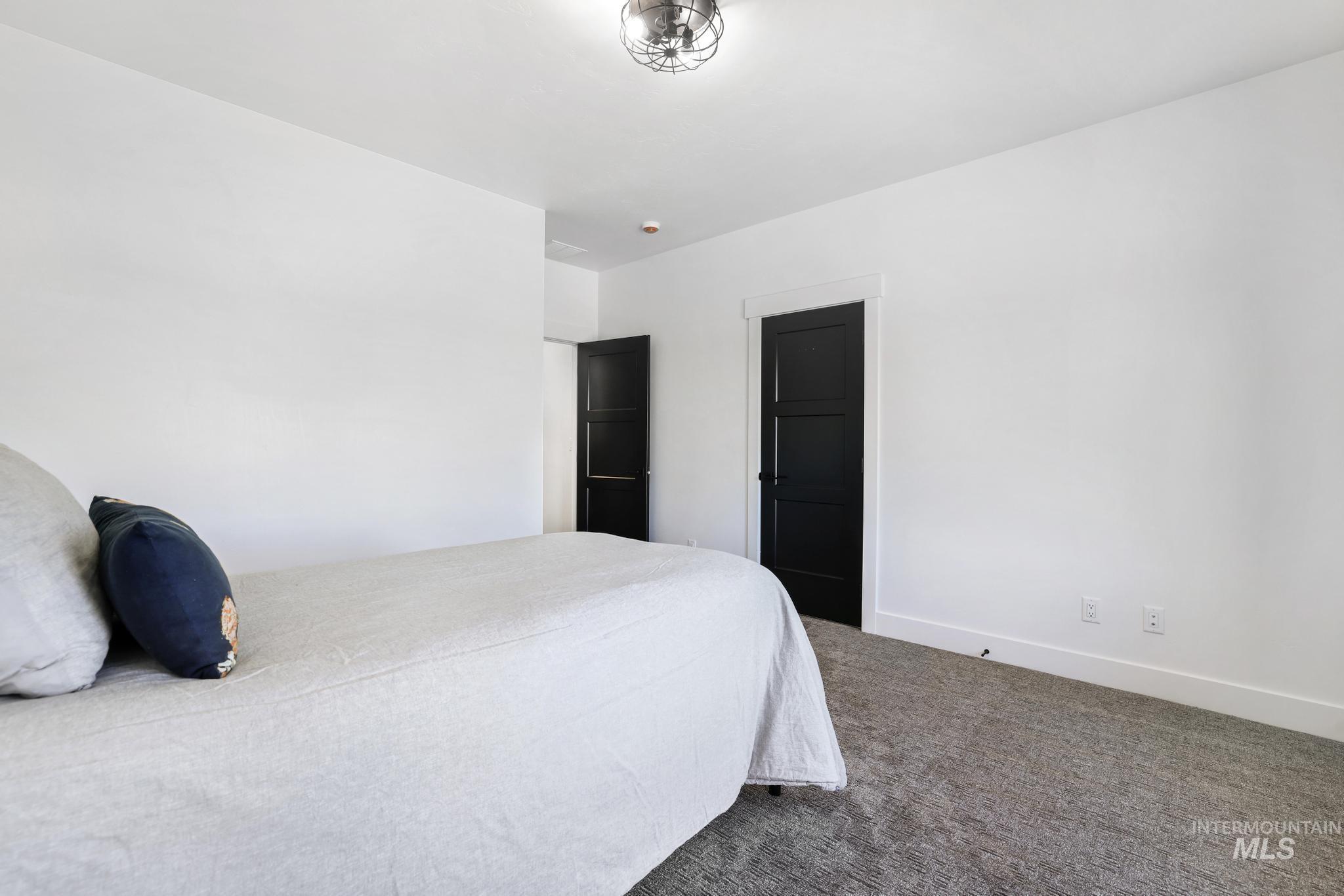 4288 North 2400 East Filer, ID 83328 - Photo 31 of 50 Bedroom featuring carpet floors and baseboards