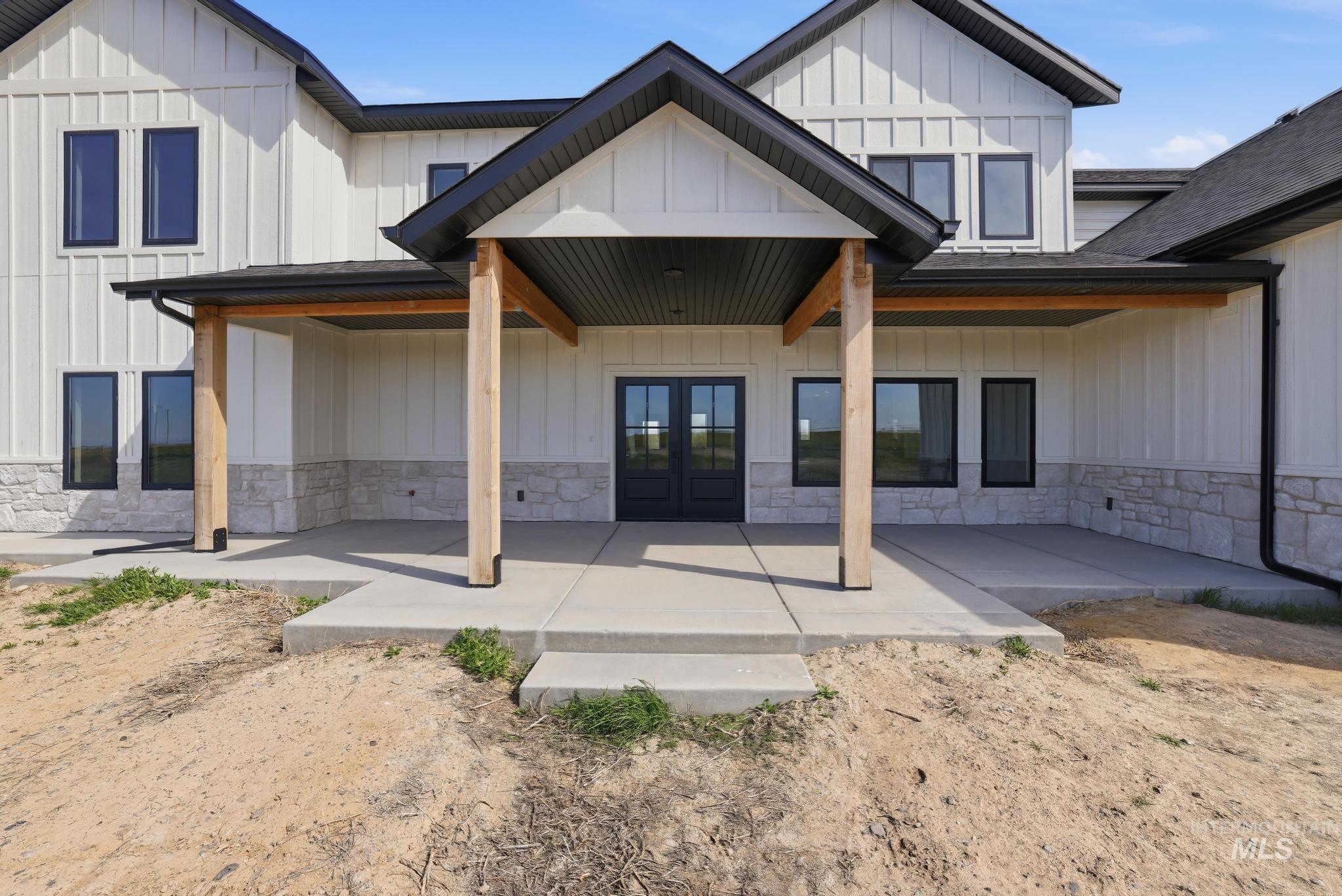 4288 North 2400 East Filer, ID 83328 - Photo 8 of 50 Back of house featuring board and batten siding, covered porch, french doors, and stone siding