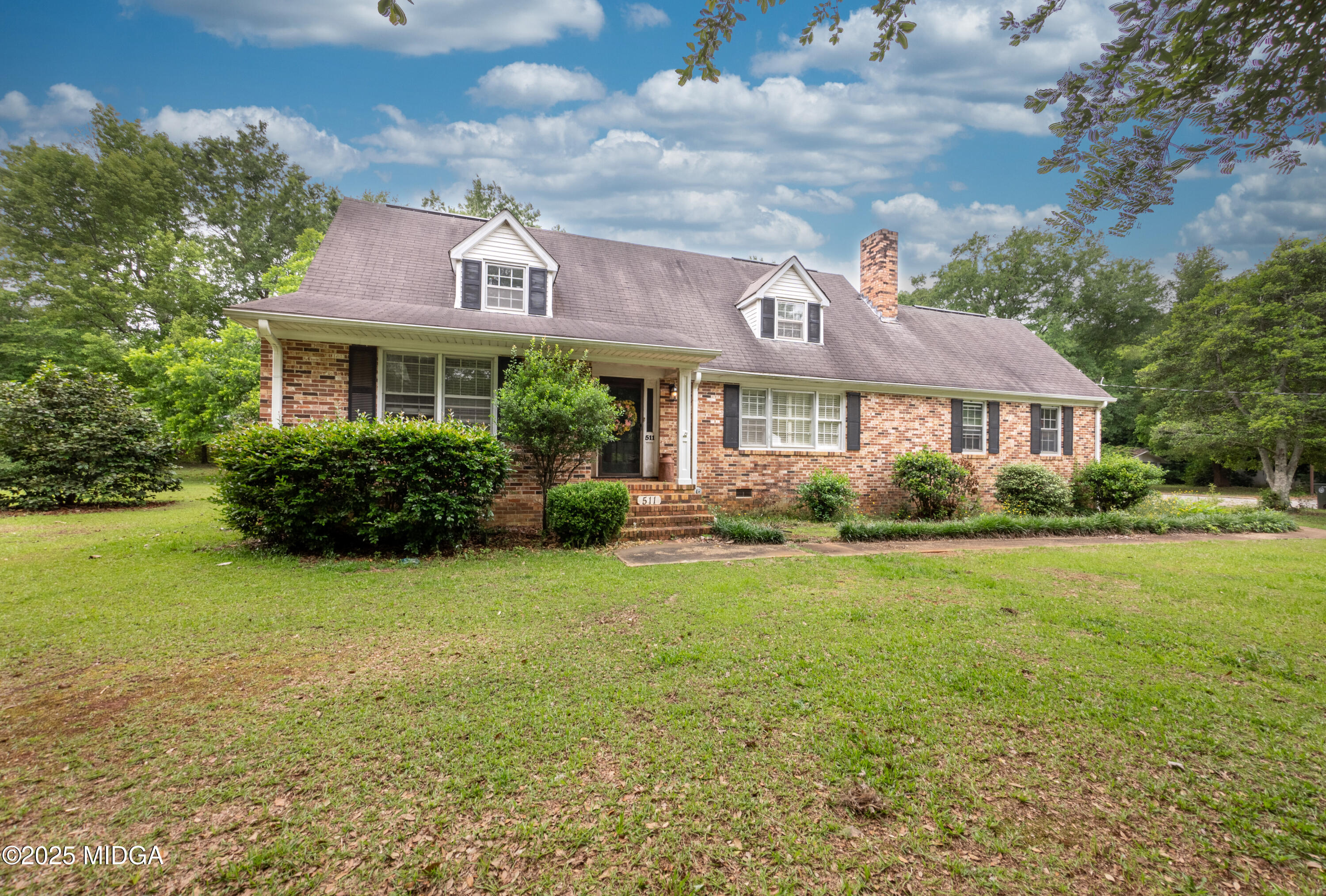 a front view of house with yard and green space