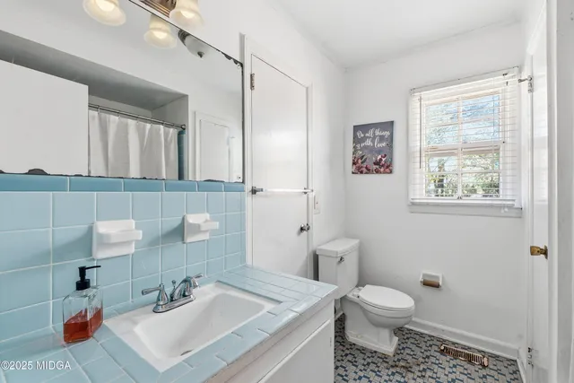 a bathroom with a sink toilet and vanity