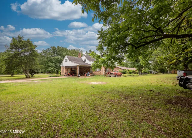 a yellow house with swimming pool in front of it
