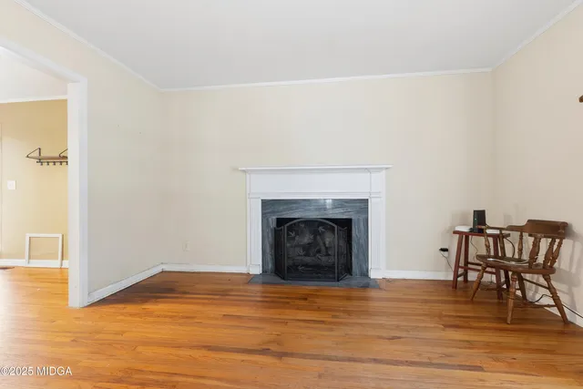 a view of a livingroom with a fireplace and a workspace