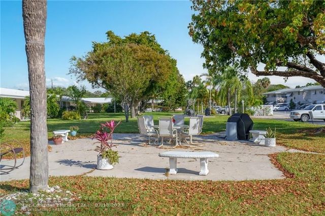 a view of yard with swimming pool and green space