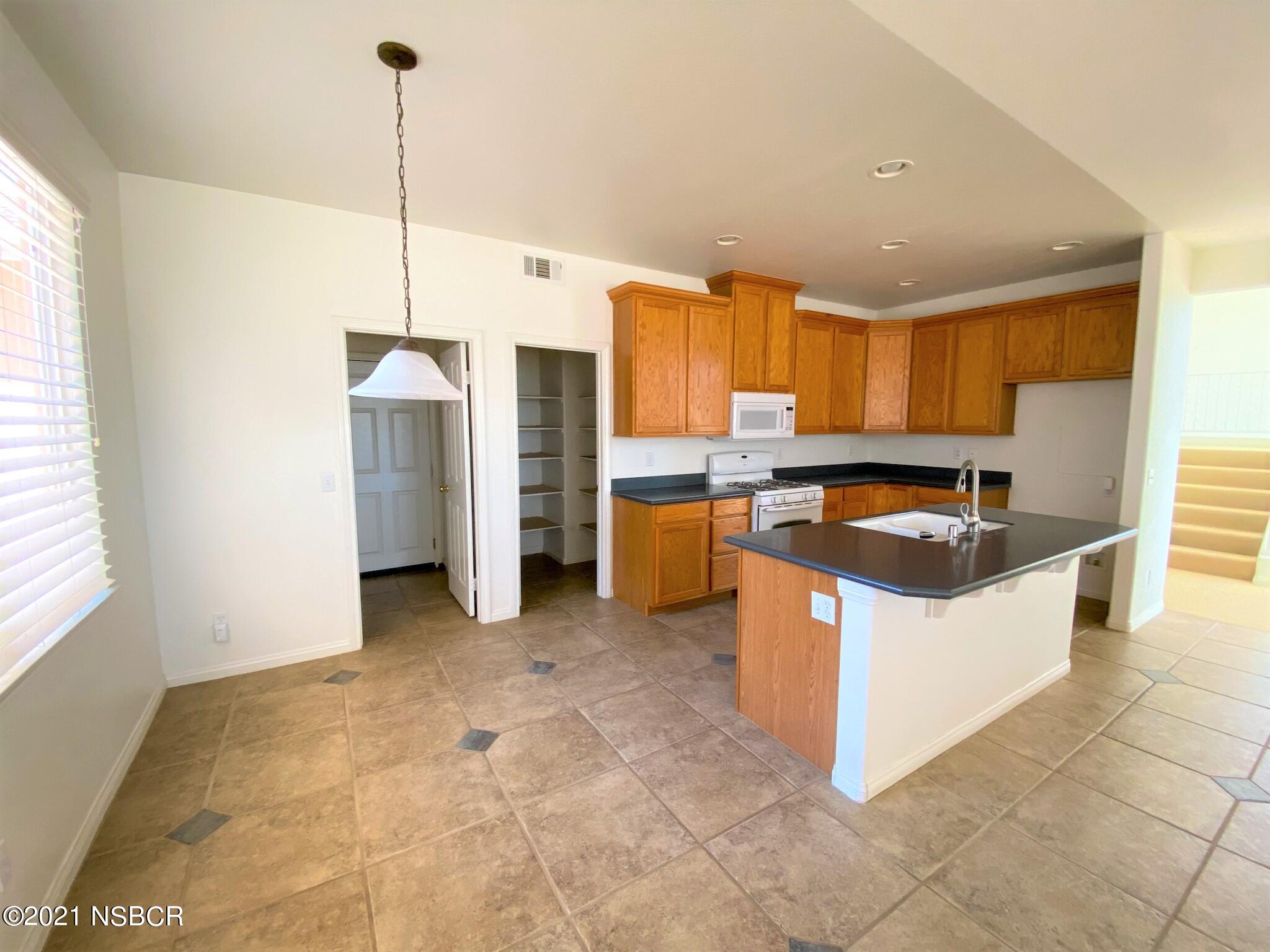 352 Ladera Lompoc, CA 93436 - Photo 8 of 35 a kitchen with stainless steel appliances granite countertop a sink a counter and a refrigerator