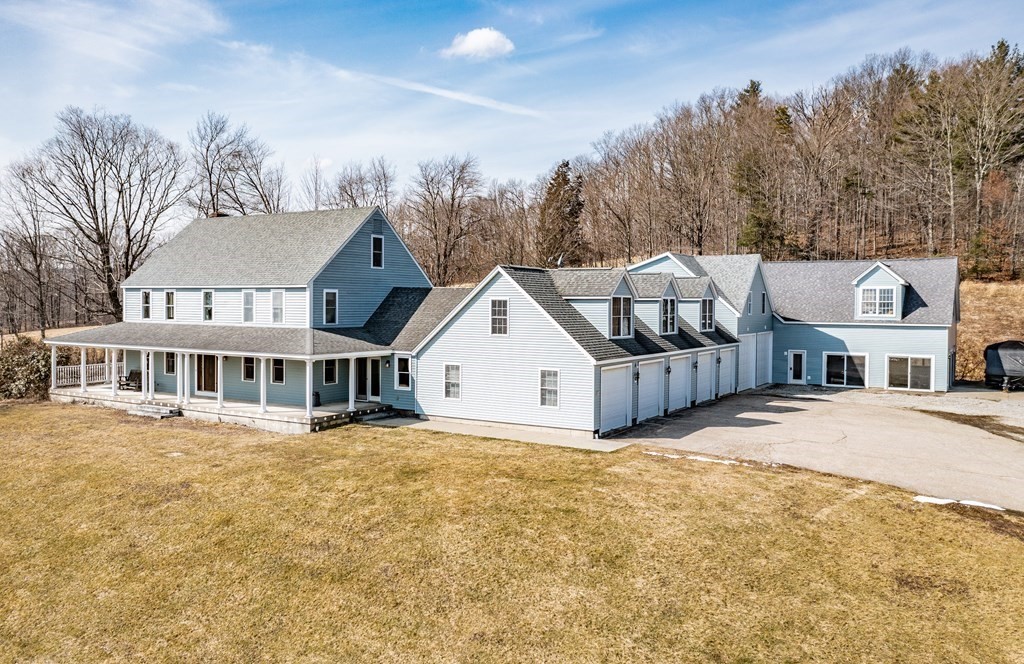 297 Brookfield Road Brimfield, MA 01010 - Photo 5 of 42 a view of a house with a big yard and large trees