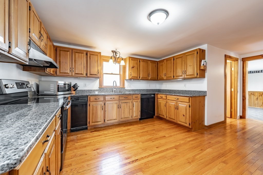 297 Brookfield Road Brimfield, MA 01010 - Photo 9 of 42 a kitchen with stainless steel appliances granite countertop a stove sink and cabinets