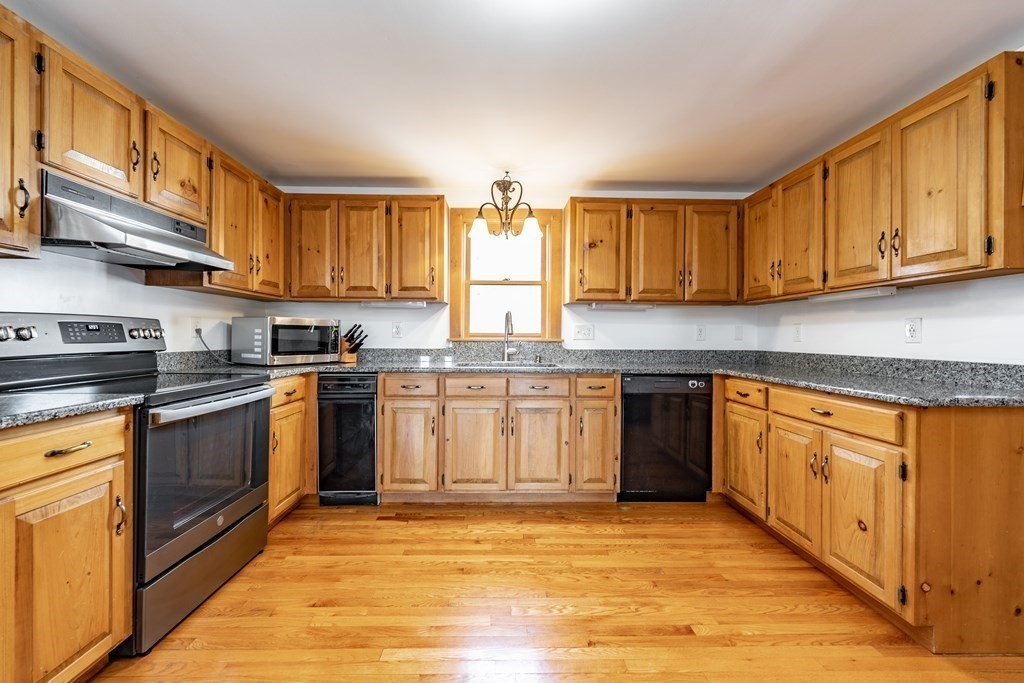 297 Brookfield Road Brimfield, MA 01010 - Photo 10 of 42 a kitchen with stainless steel appliances granite countertop a stove sink and cabinets