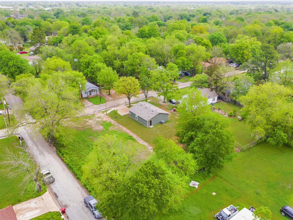921 West 9th Street Bonham, TX 75418 - Photo 21 of 22 Aerial perspective of suburban area with a forest