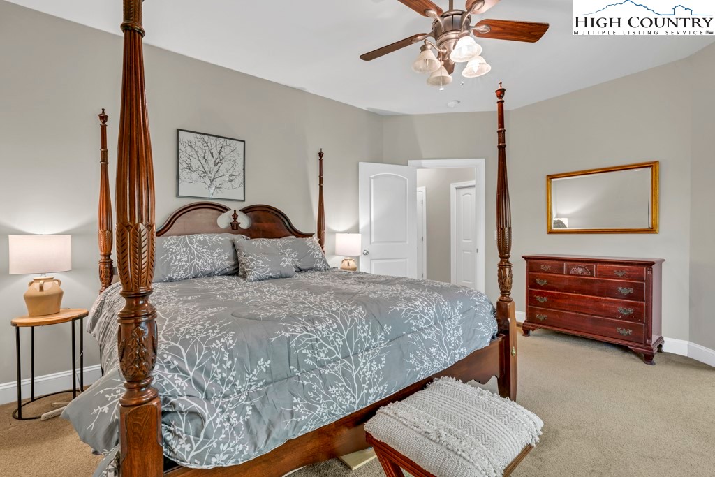 100 Northridge Road Beech Mountain, NC 28604 - Photo 14 of 32 a bedroom with a bed and a chandelier