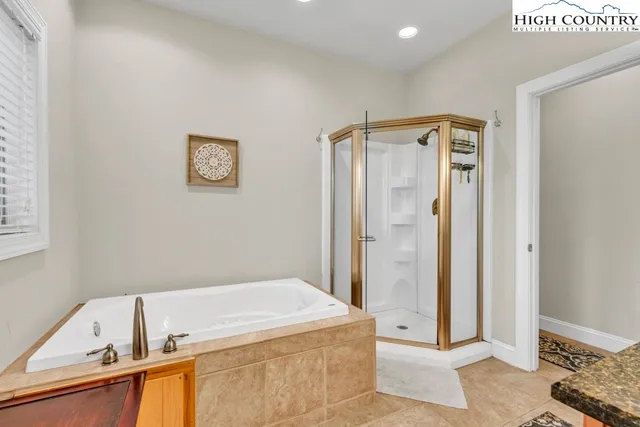 a bathroom with a tub and shower