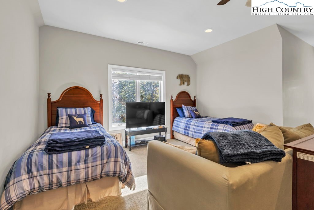 100 Northridge Road Beech Mountain, NC 28604 - Photo 19 of 32 a bedroom with a bed and a lamp