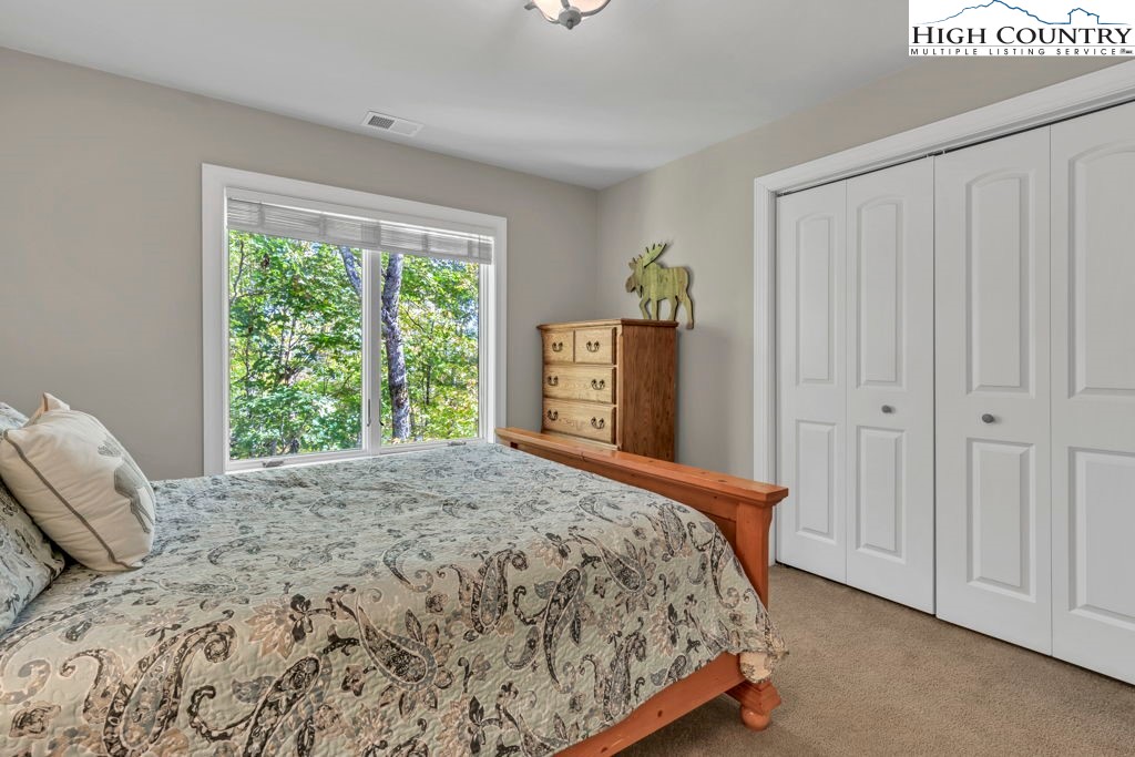 100 Northridge Road Beech Mountain, NC 28604 - Photo 22 of 32 a bedroom with a bed and a window