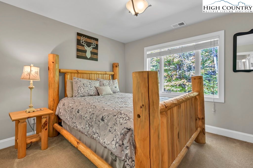 100 Northridge Road Beech Mountain, NC 28604 - Photo 24 of 32 a bedroom with a bed and a table