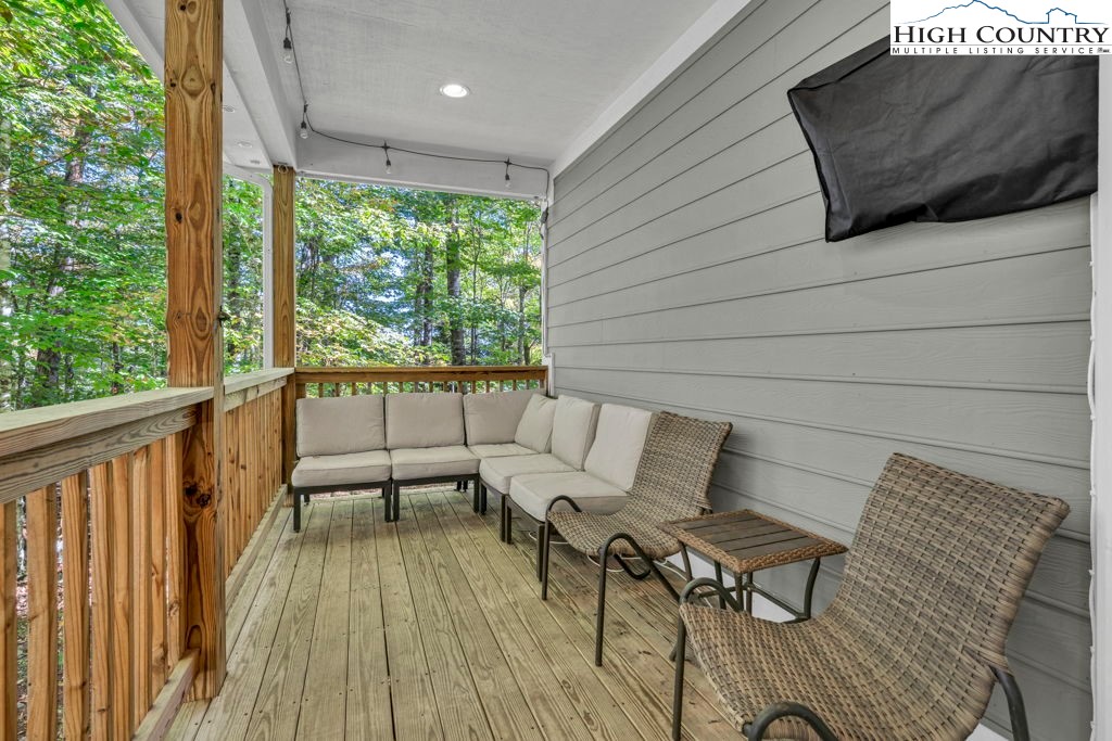 100 Northridge Road Beech Mountain, NC 28604 - Photo 29 of 32 a view of a patio with table and chairs with wooden floor and fence