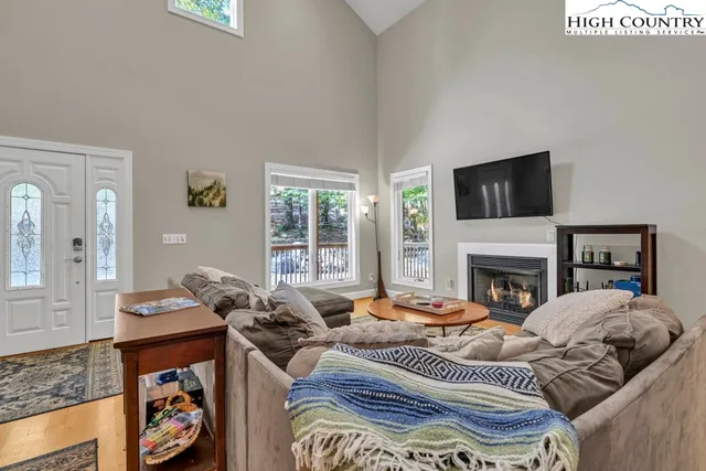a living room with furniture fireplace and flat screen tv