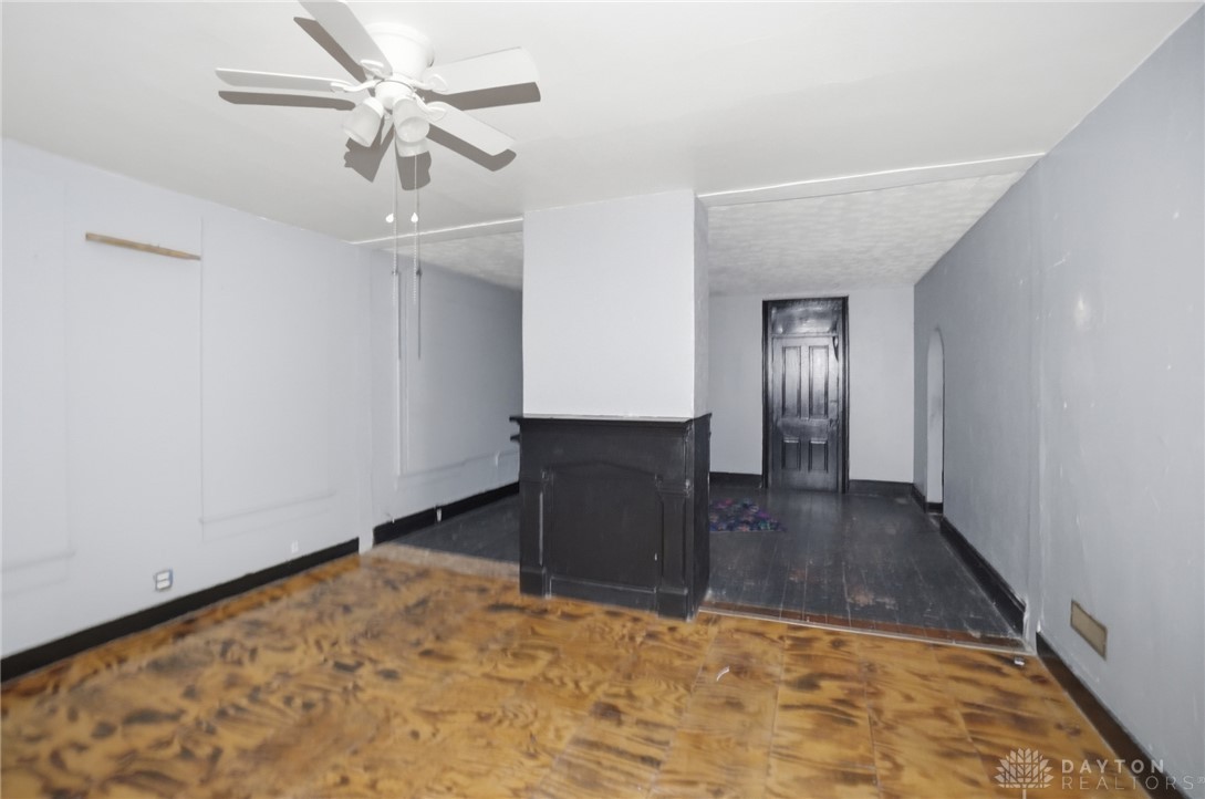 517 Broadway Street, Unit 515 Springfield, OH 45504 - Photo 19 of 29 This versatile space features a ceiling fan, fireplace, and hardwood floors.