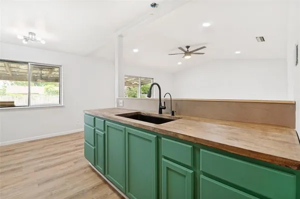 a kitchen with a sink a stove and cabinets