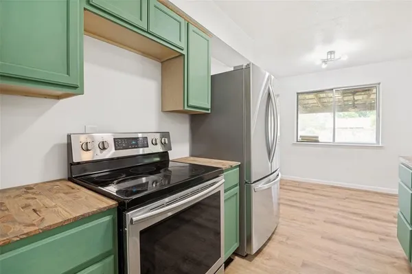 a kitchen with stainless steel appliances granite countertop a stove and a refrigerator