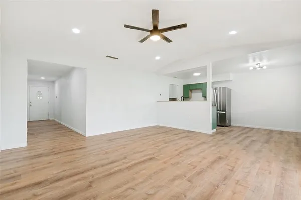 a view of an empty room with a ceiling fan