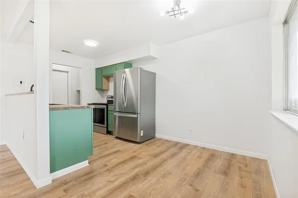 a kitchen with a refrigerator and a sink