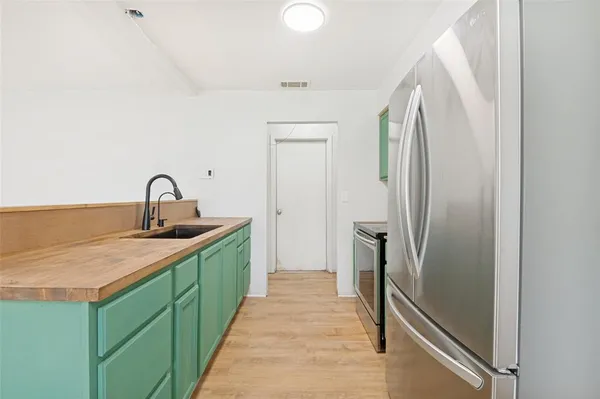 a kitchen with a sink and refrigerator