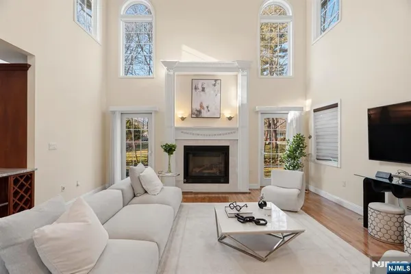 a living room with furniture a fireplace and a flat screen tv