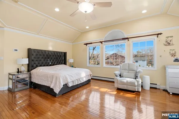 a bedroom with a large bed and a couch